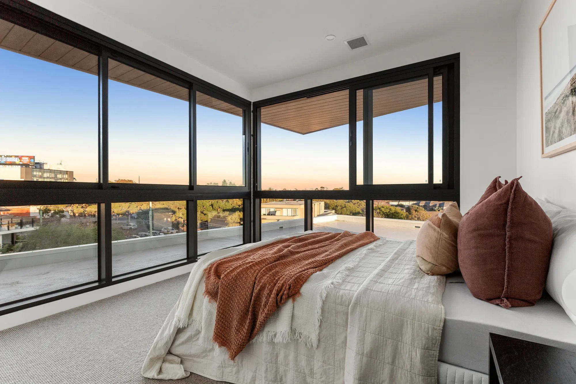 Corner bedroom with floor-to-ceiling windows at Iridian